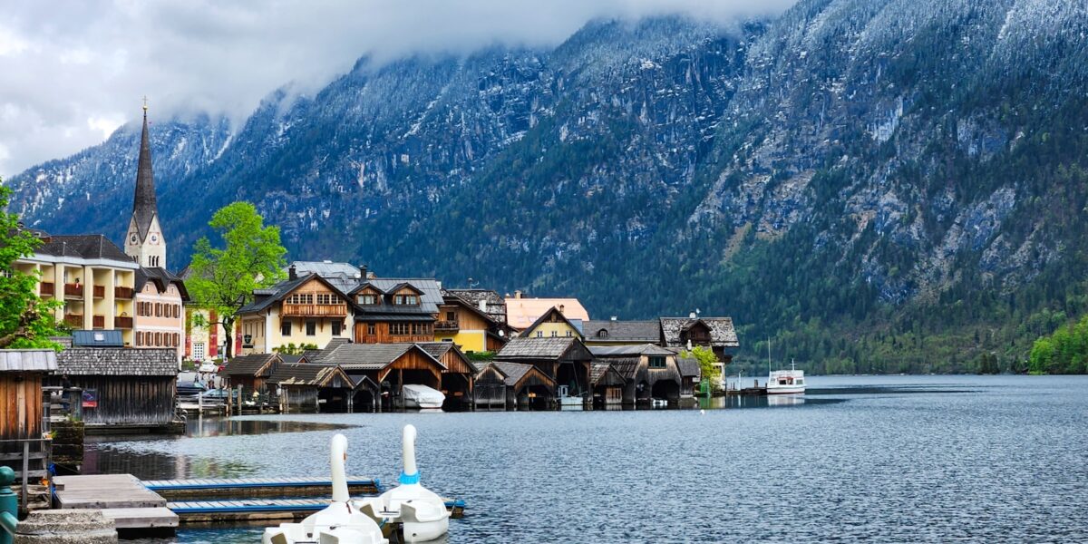 A body of water surrounded by mountains and houses